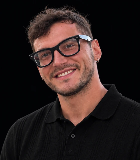 Close-up color portrait of Matteo Dante smiling with glasses and a black polo shirt